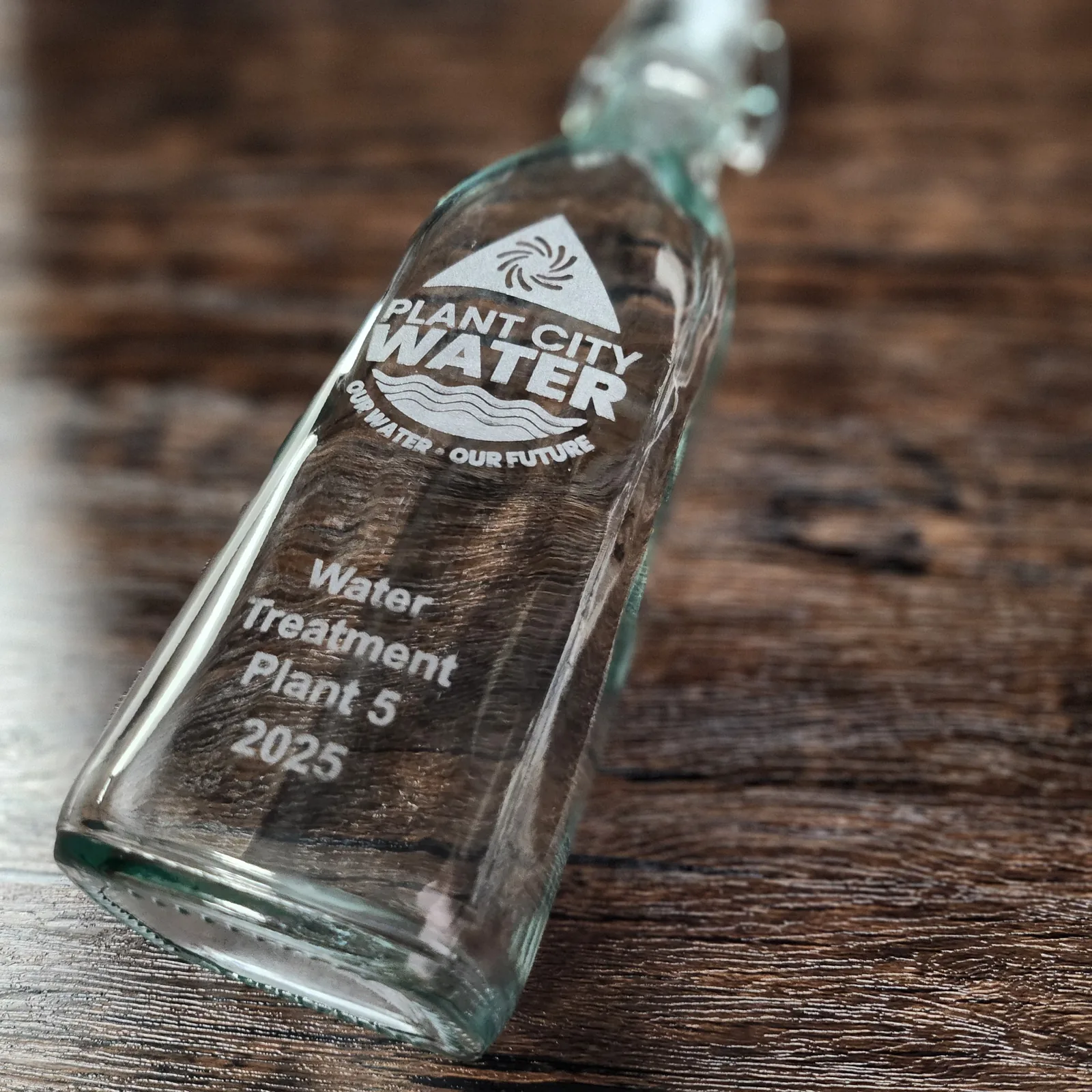 Engraved glass logo bottle